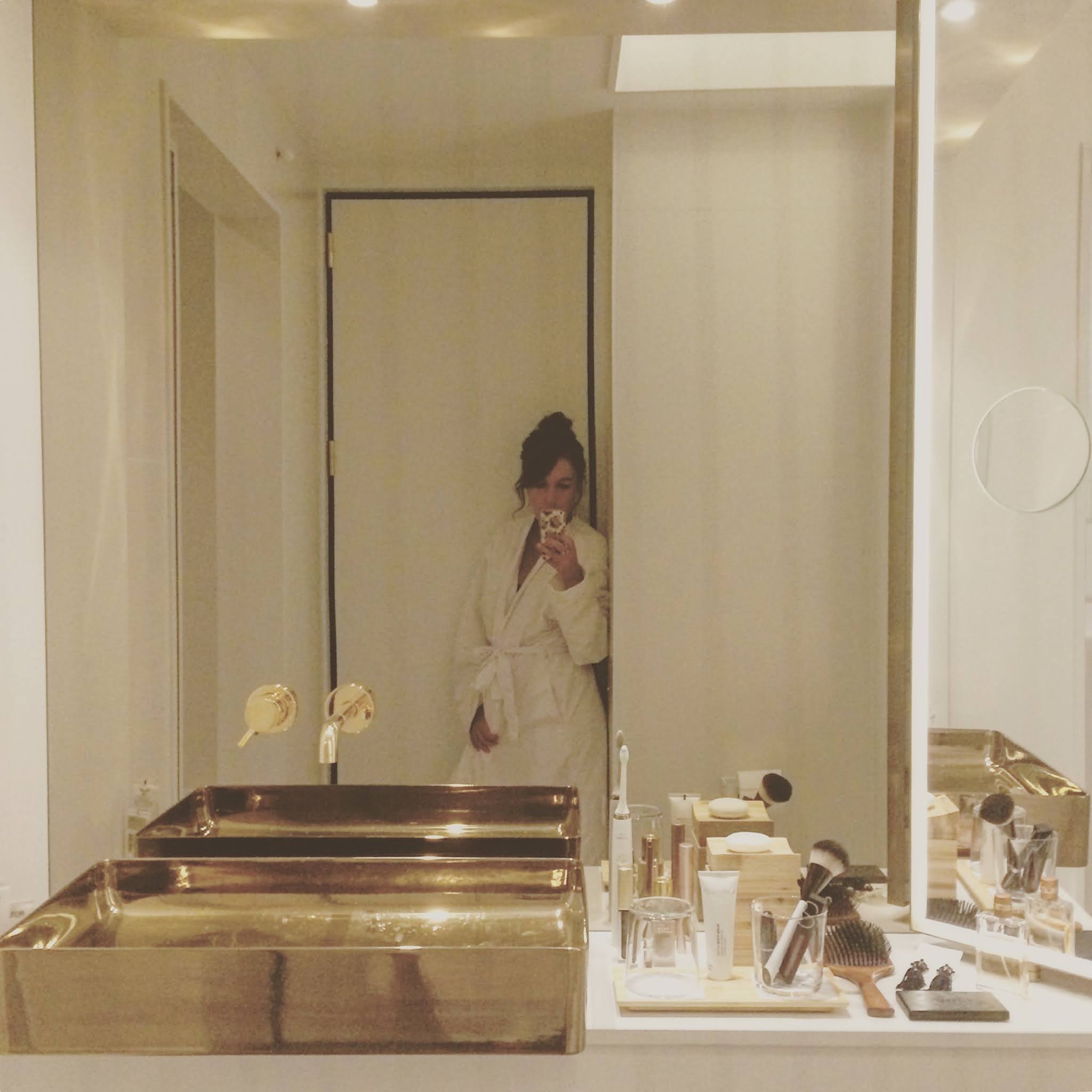 girl reflected in mirror of nobu hotel bathroom