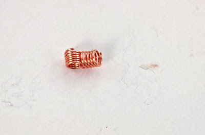 Pick two short coils, and insert one of one coil into the center of the other coil