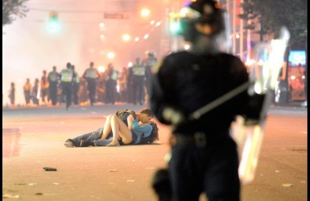 35 moments of violence that brought out incredible human compassion - an injured woman is helped by her boyfriend after disappointed hockey fans turn violent