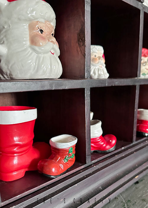 Santa mug and Santa boot collection in vintage cubbies.