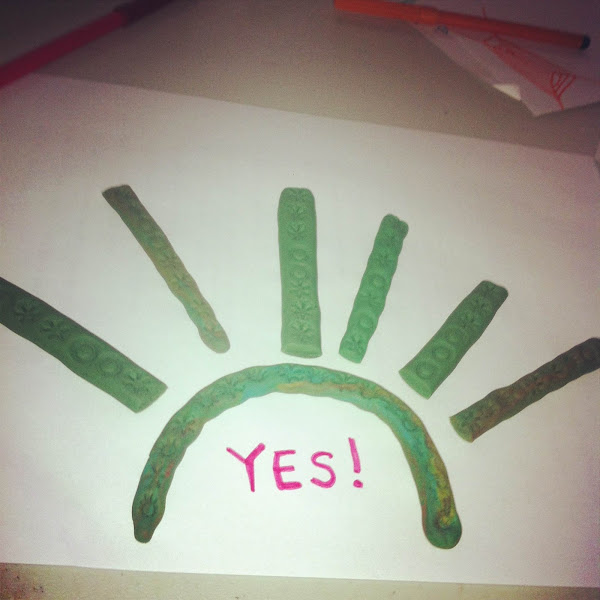 painting of a sort of sunburst, with the word 'yes'