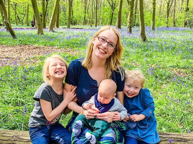 Family photo in front of Bluebells in chalet wood Wanstead Park