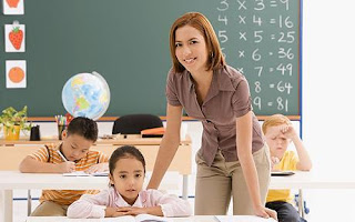 Teacher with primary pupils in classroom