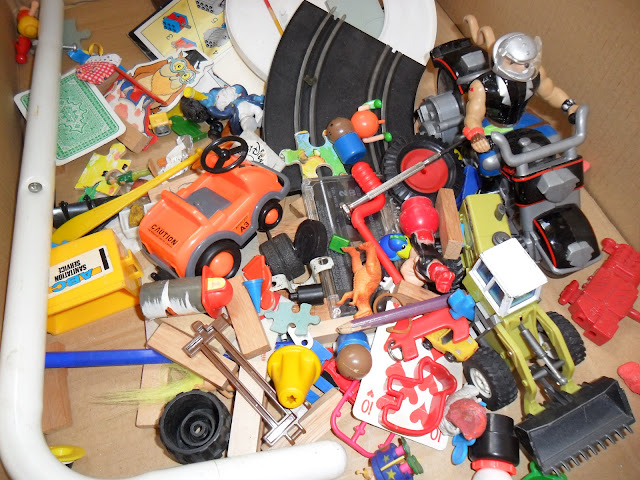 A box filled with random toys after sorting out the Playmobile box.