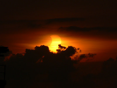 Sunset and partial eclipse