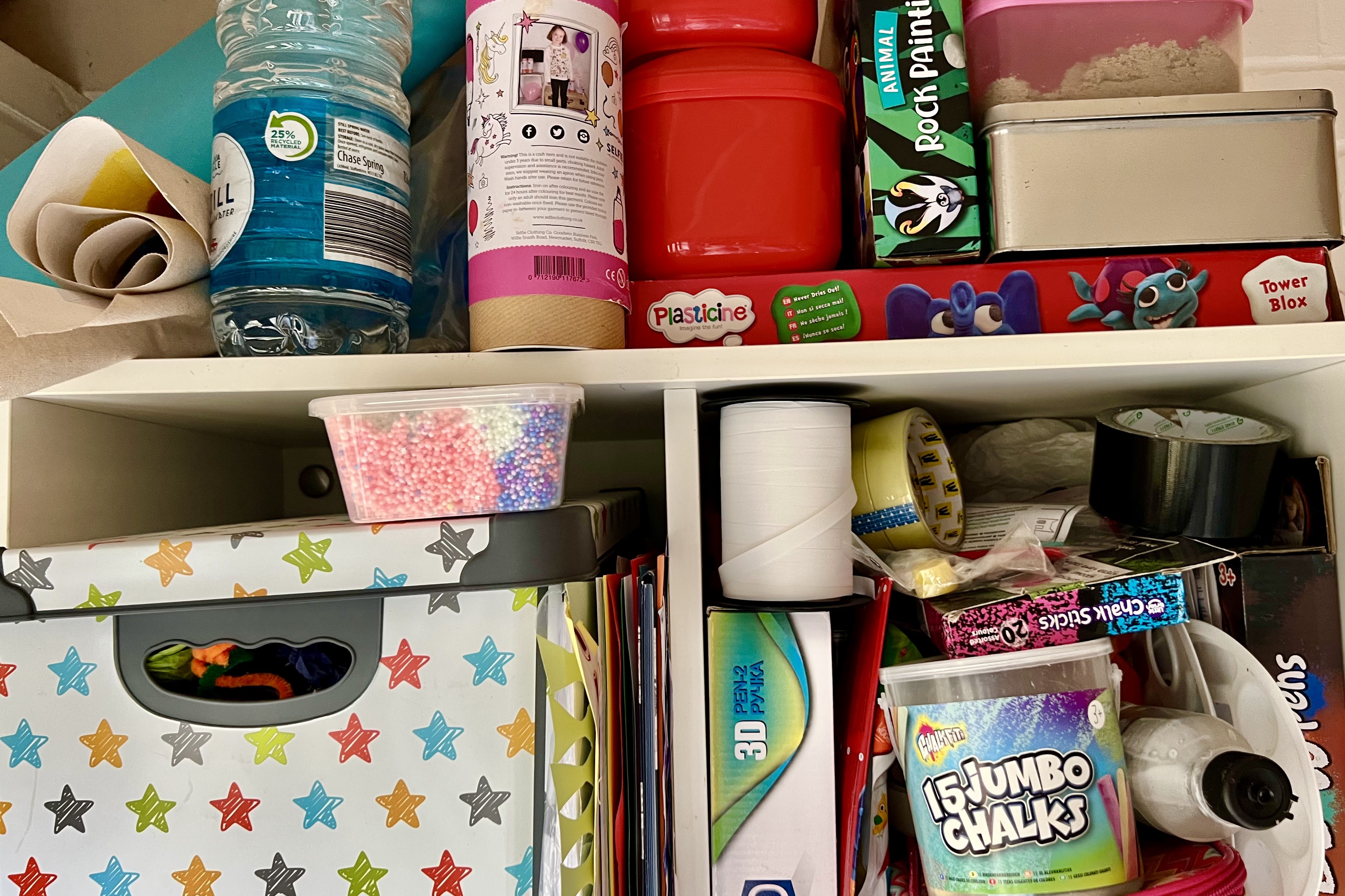 Shelves filled with arts and crafts in a big mess