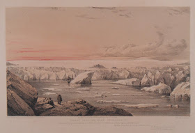 Icebergs in a channel with a pink sky backdrop