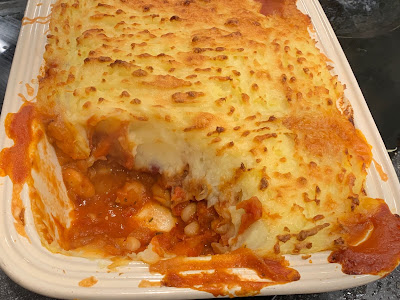 Cheesy Mashed Potato and Bean Bake with a portion removed