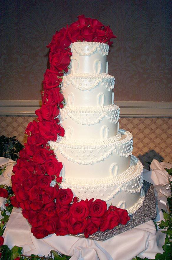 Classic and elegant wedding cake with red ribbons and red roses