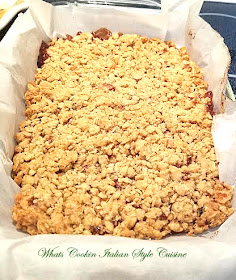 An old fashioned cookie bar filled with raspberry jam and has an oatmeal crust