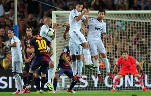 Barcelona player Lionel Messi takes a free-kick to score a goal against Real Madrid