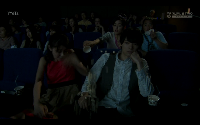 Matsumoto tries to hold Naoki's hand but Kotoko hits her with some airborne popcorn. 