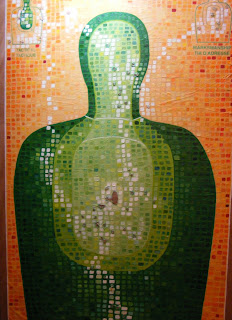 Target 1, a mixed media painting in progress by Kate MacDonald. 24 x 36 - paint and shooting practice target on wooden panel.