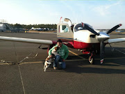 Sid and Enzo in front of the Mooney from a prior trip