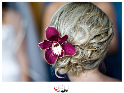  orchids in their updos and held a clutch of lilac and champagne roses