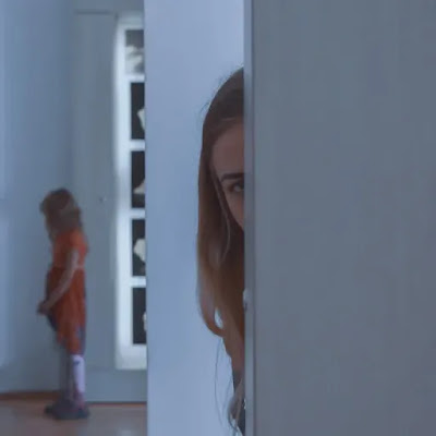 An image of a sad girl hiding behind the doors- sad girl dp