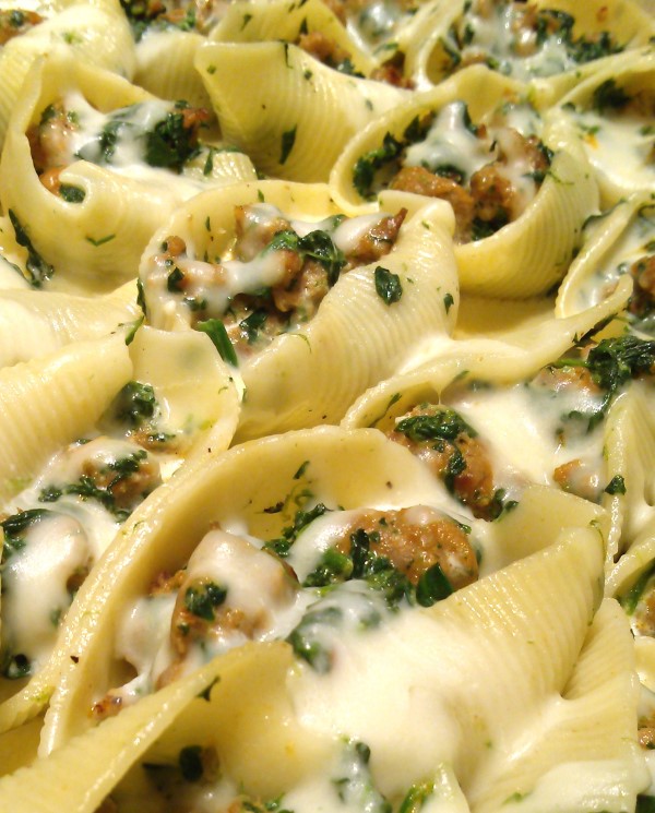 Sausage & Spinach Stuffed Shells with Garlic Cream! A rustic, simple recipe for stuffed pasta shells with Italian sausage, spinach and mozzarella topped with an easy garlic cream sauce.