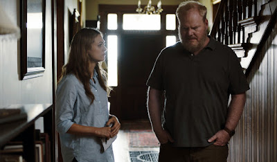 Marin Ireland and Jim Gaffigan listen for a sign that his dead wife might be a ghost in his house in a movie still for the Sundance film Light from Light (2019)