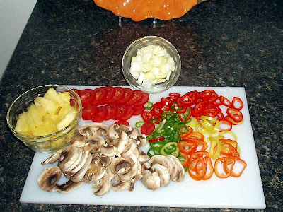  These are all the toppings for my pizza. Along with the peppers are some of our tomatoes and onions. The pineapple was store-bought. 