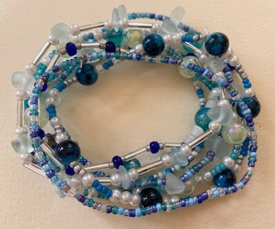 Stretch beaded bracelet pile in blue and turquoise with ocean theme