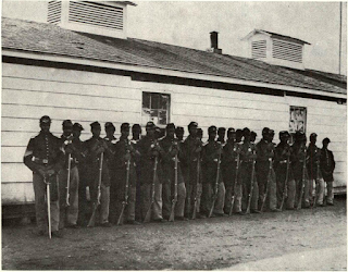 Bright 40" barrel Enfield rifles larvis had made for Colt to sell have never been identified by collectors, but this wartime photo of Co. E, 4th U.S. Colored Infantry at Fort Lincoln, shows such arms issued in hands of troops. Close examination with magnifying glass confirms that bright barrels and bands are reflecting light and are not just retouched. Enfields held by first and second men in line compare with bright Colt Special Model held by third man.