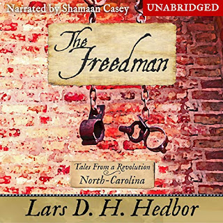 Audiobook cover of The Freedman: Tales From a Revolution - North-Carolina. A pair of manacles hang in front of a brick wall.