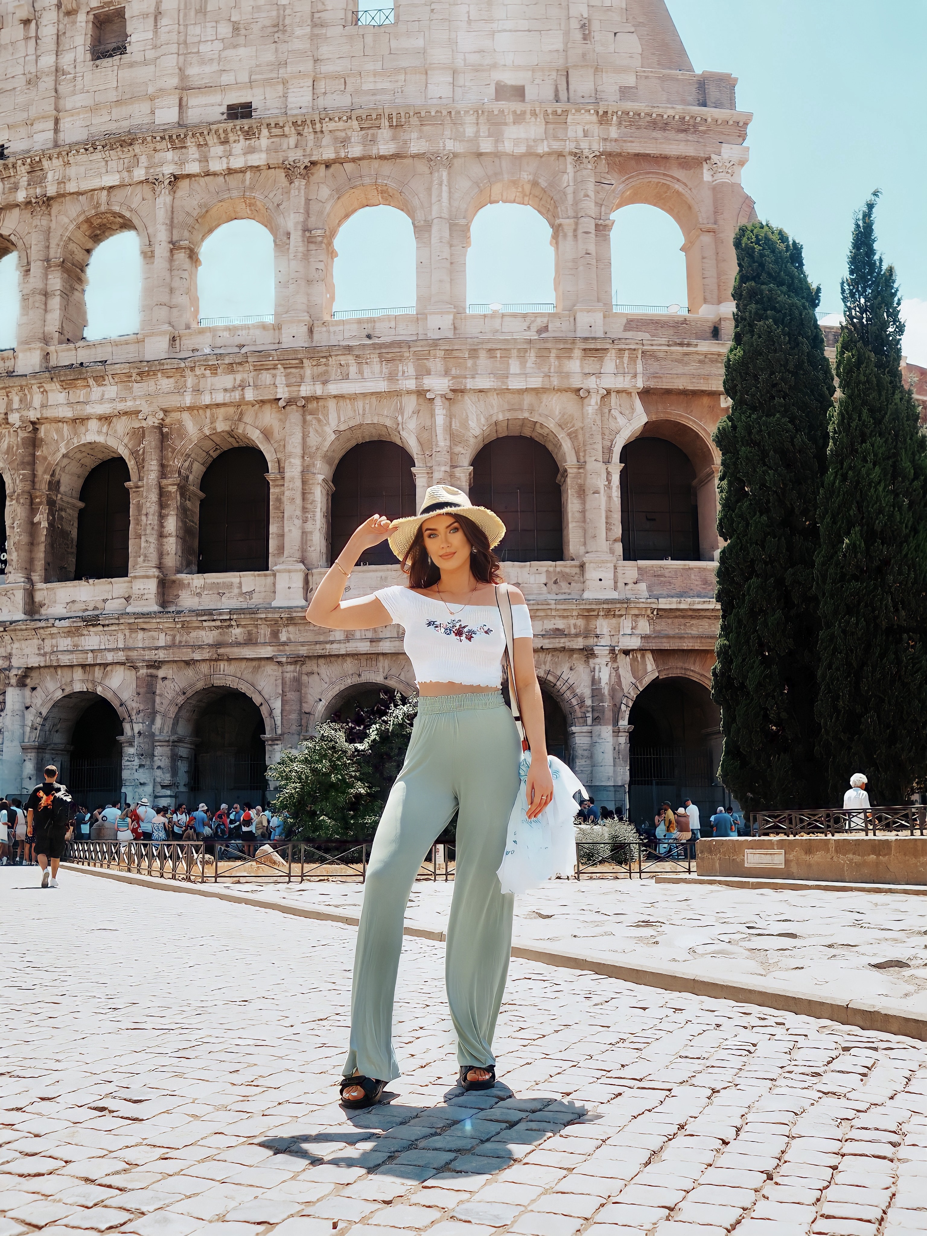 Terri standing in front of the Roman Colosseum in Italy.