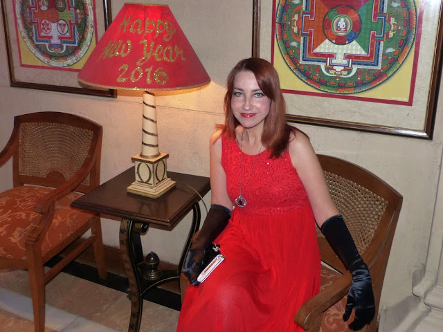 New Year party outfit: red dress worn with long black gloves