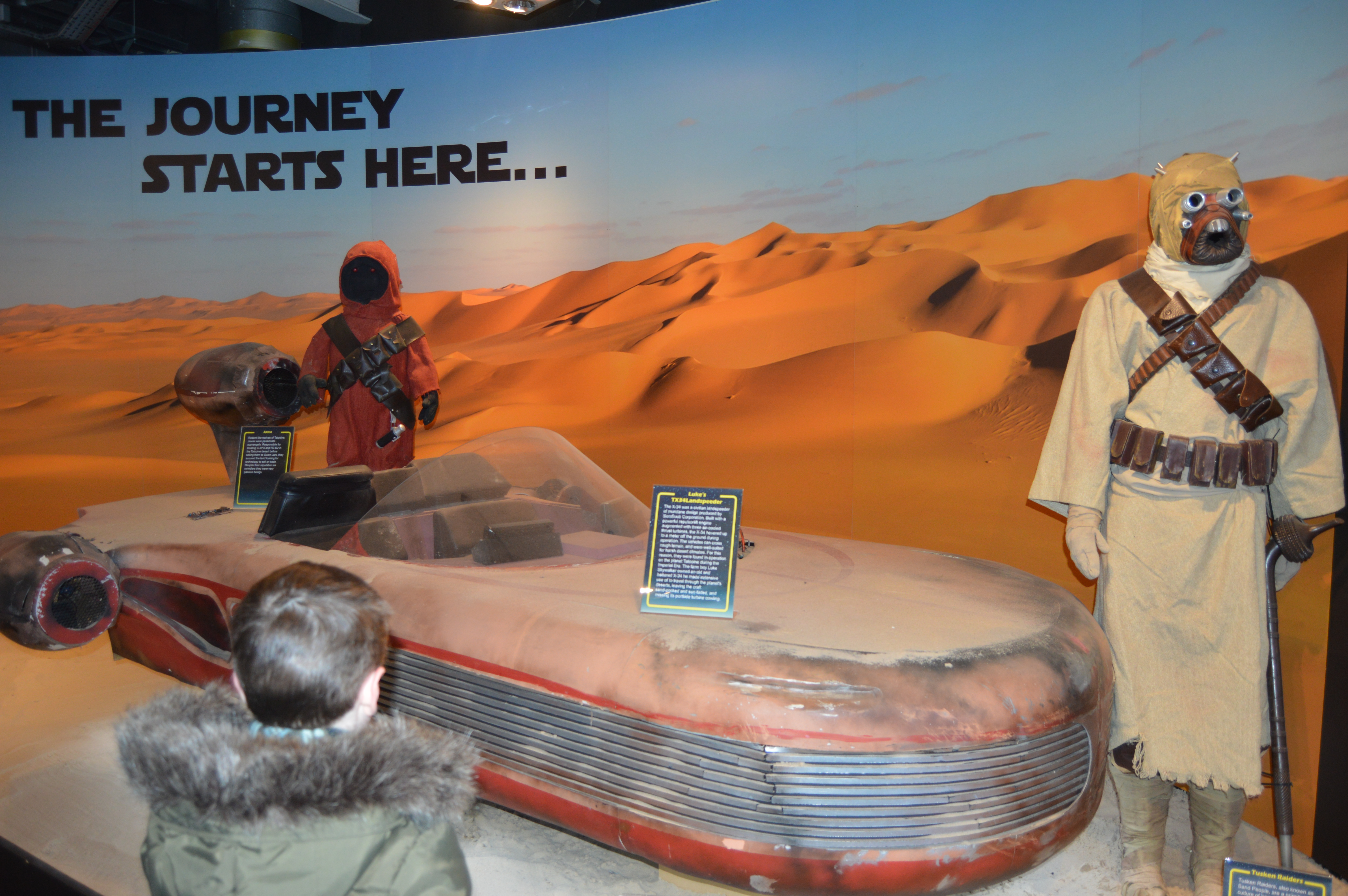 Boy looking at a star wars attraction