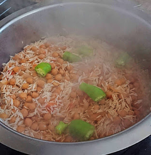 adding the green chilies on top for the last step of vegan chana pulao