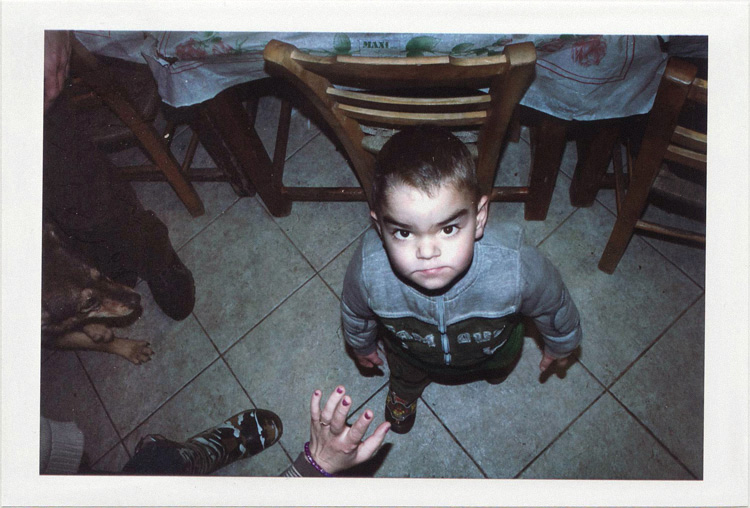 dirty photos - upon - flash street photo of angry little boy looking up in taverna