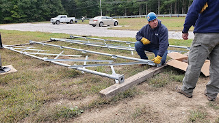 laying out pieces of what looks like an industrial strength Erector Set