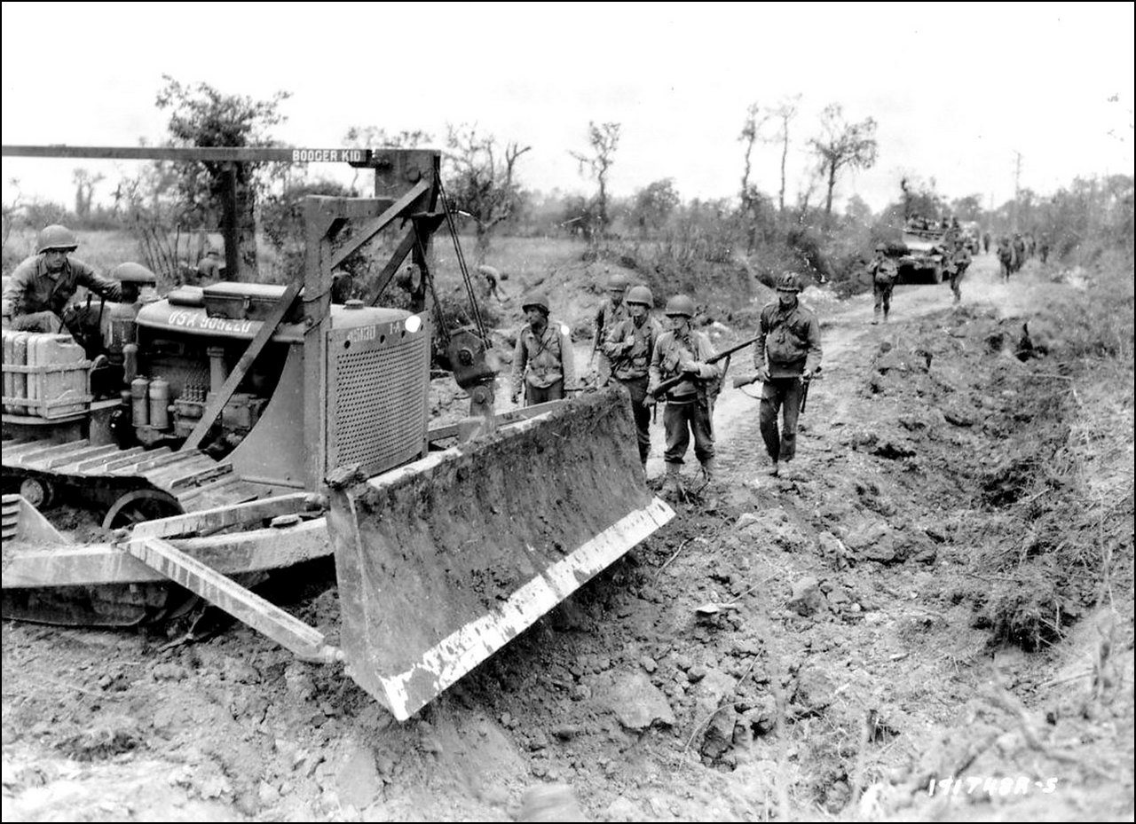 Caterpillar D7  Bulldozer D7%20with%20a%20angledozer%20LeTourneau%20equipment%20and%20CK7%20called%20booger%20kid%20recorks%20holes%20bombs%20on%20a%20road%20of%20the%20Normandy%20countryside%20west%20of%20St.%20Lo.