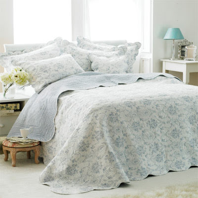 bedroom showing light blue quilted bedspread, opulent