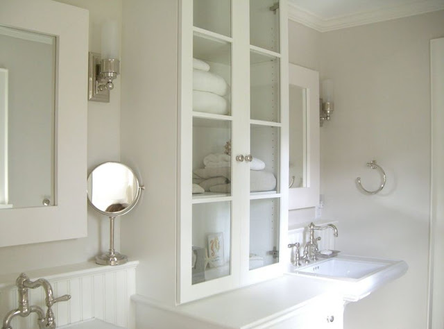 white small bath with storage medicine cabinets pedestal sinks