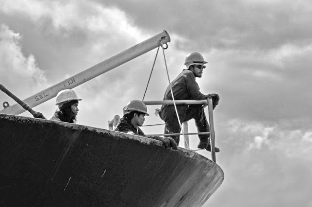 Crew on the bow of their ship in harbour of Terneuzen