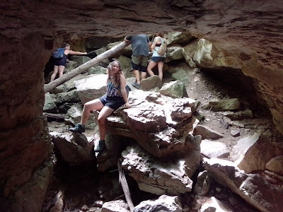 Girl posing at cave entrance