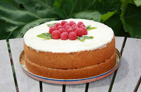 Lemon and raspberry Madeira cake topped with lemon buttercream and raspberries