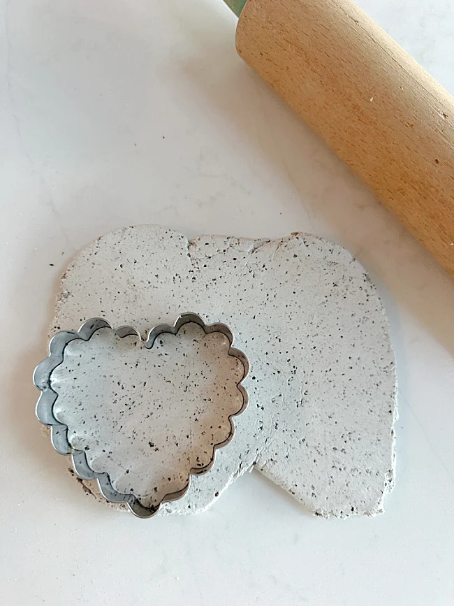 rolling pin and cookie cutter in the clay