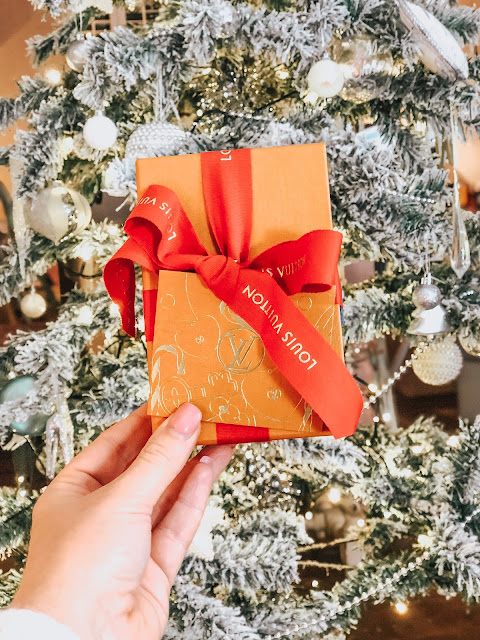 louis vuitton box gift wrapped in front of christmas tree