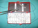 A needle counter containing sutures post-op