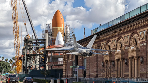 At the California Science Center in Los Angeles, the retired F/A-18 Hornet photobombs Endeavour's Space Shuttle Stack as it stands tall inside the construction site for the Samuel Oschin Air and Space Center...on February 2, 2024.