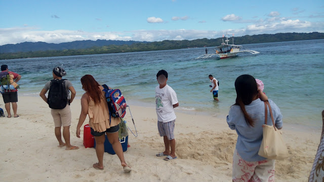 passengers waiting to board the boat going back to mainland from Canigao Island in Matalom, Leyte