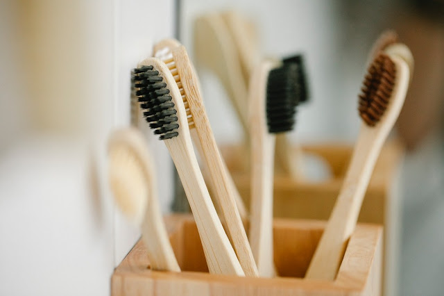 Several bambbo toothbrush in a container