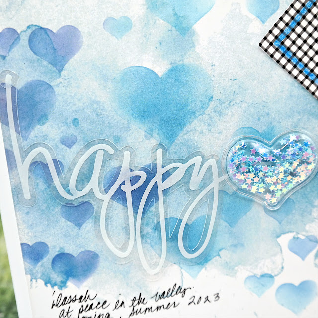 Happy Acetate Die-Cut Title and Heart Shaker Embellishment Filled with Blue Sequin Stars on a Mixed Media Scrapbook Layout