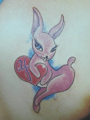 interesting purple rabbit tattoo design on hand