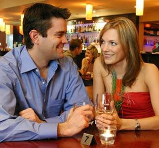 Man on a speed dating with a sexy woman in a bar