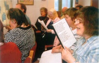 Close-up of lady using Giant Print hymn book at a service