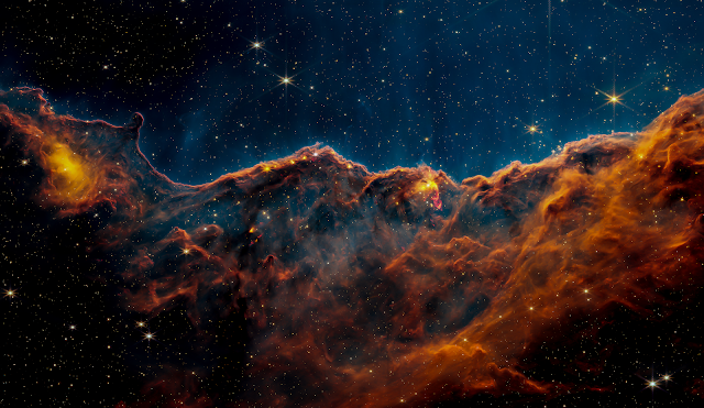 mage of the Cosmic Cliffs, a region at the edge of a gigantic, gaseous cavity
within NGC 3324, captured by Webb’s Near-Infrared Camera (NIRCam). Click the
download button now and enjoy the beauty of the Carina Nebula on your screen.