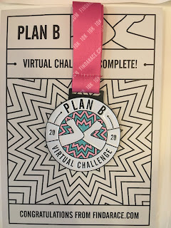 Plan B medal with cardboard backing